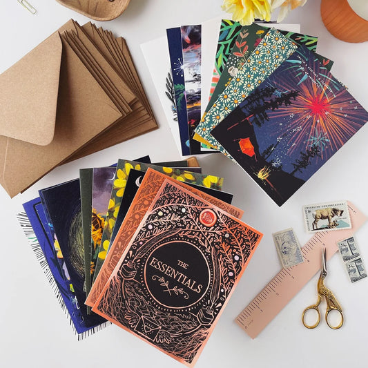 Assortment of cards on a table with a stack of envelopes