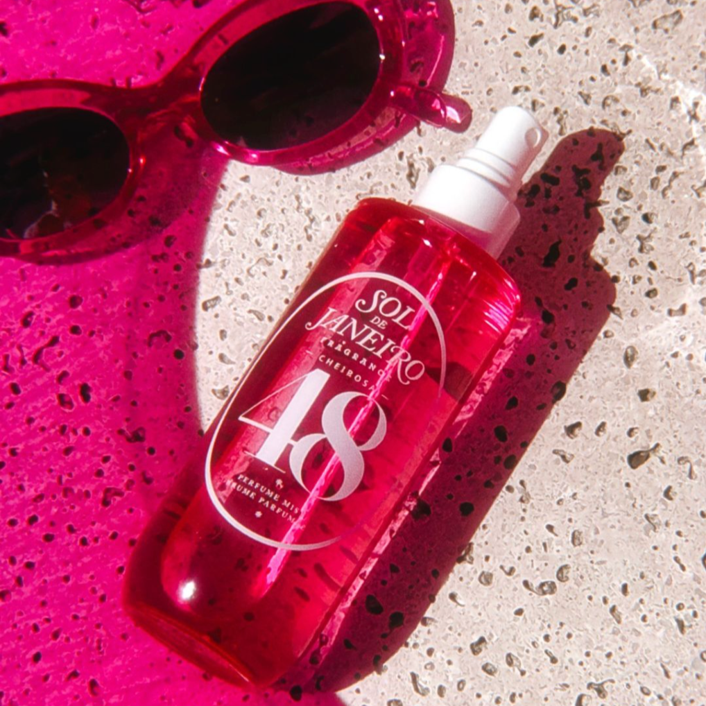 Cheirosa 48 Perfume Mist in pink bottle next to sunglasses
