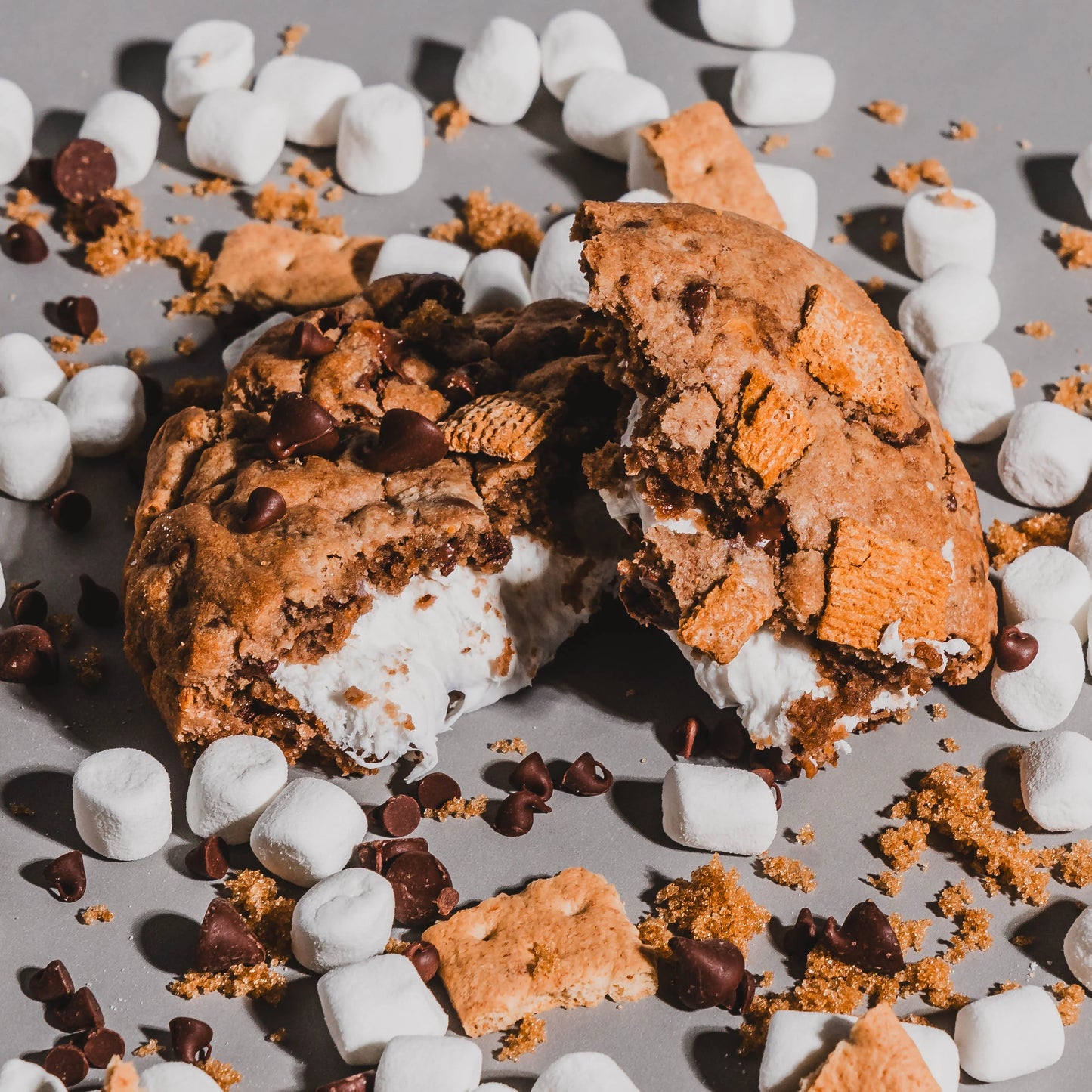 Cookie broken shows ingredients of chocolate chips, graham bits and mini marshmallows