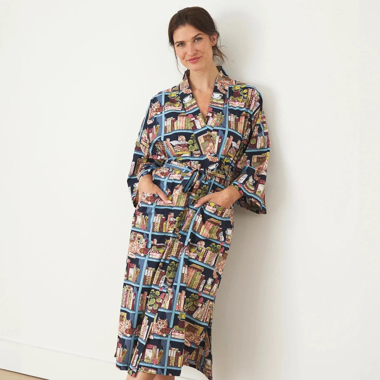 model wearing secret library robe with hands in pockets