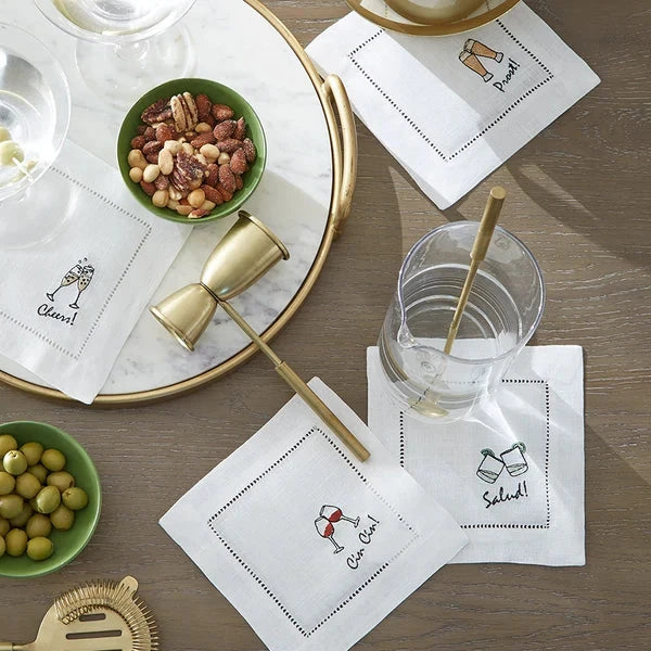 set of four cocktail napkins with cheers in different languages with different drinks