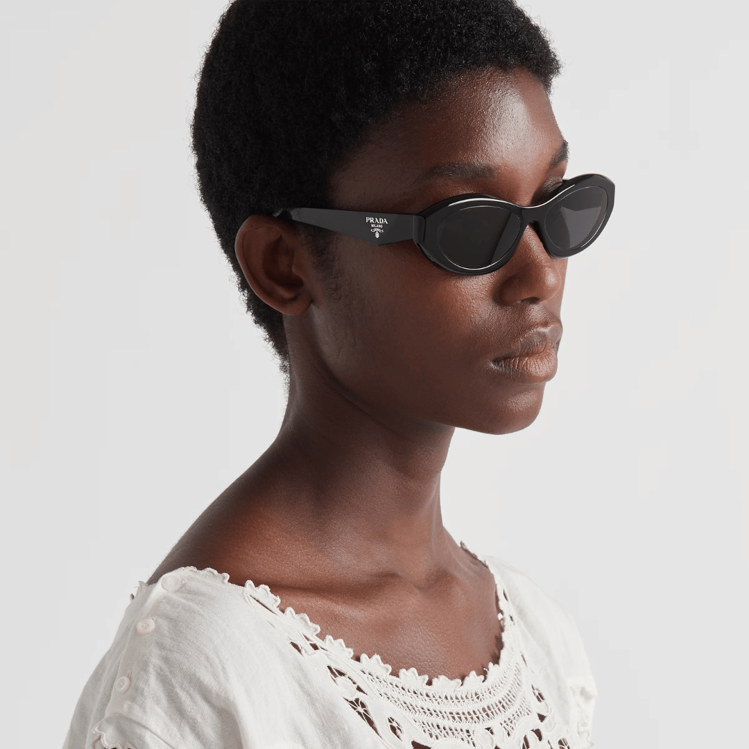 female model wearing black small prada sunglasses