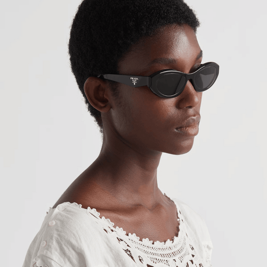 female model wearing black small prada sunglasses