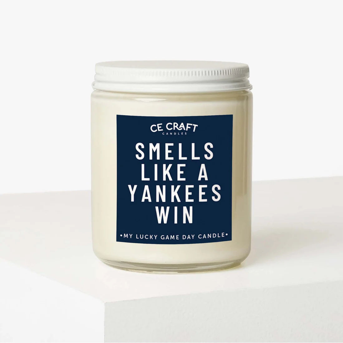 candle in a clear jar with "Smells like an Yankees win" printed on label