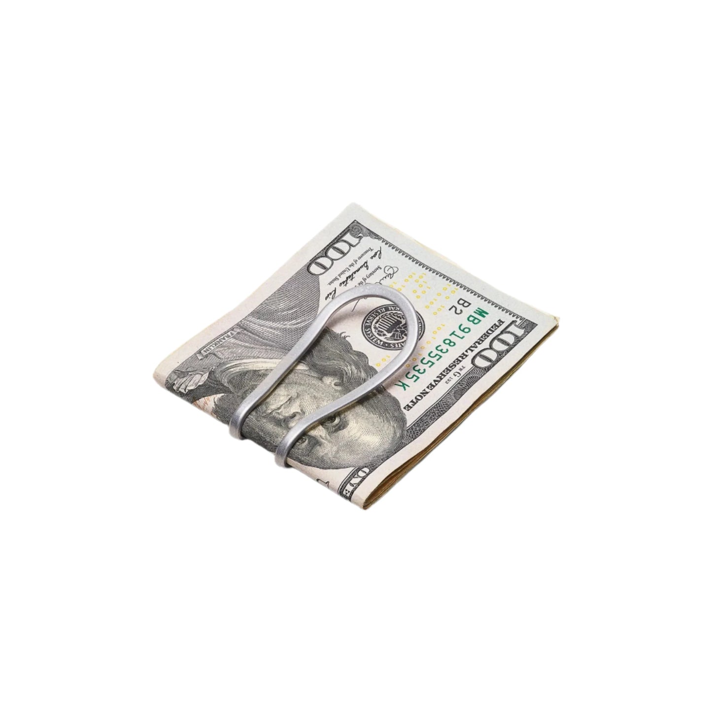 silver money clip holding $100 bills