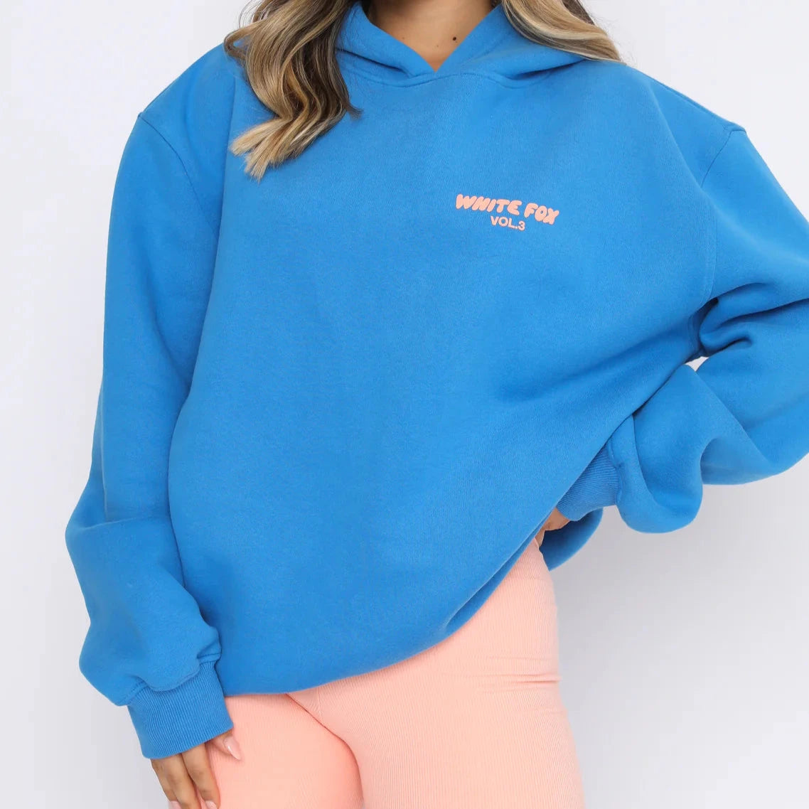 blue hoodie with chest detai that says vol 3 white fox in pink