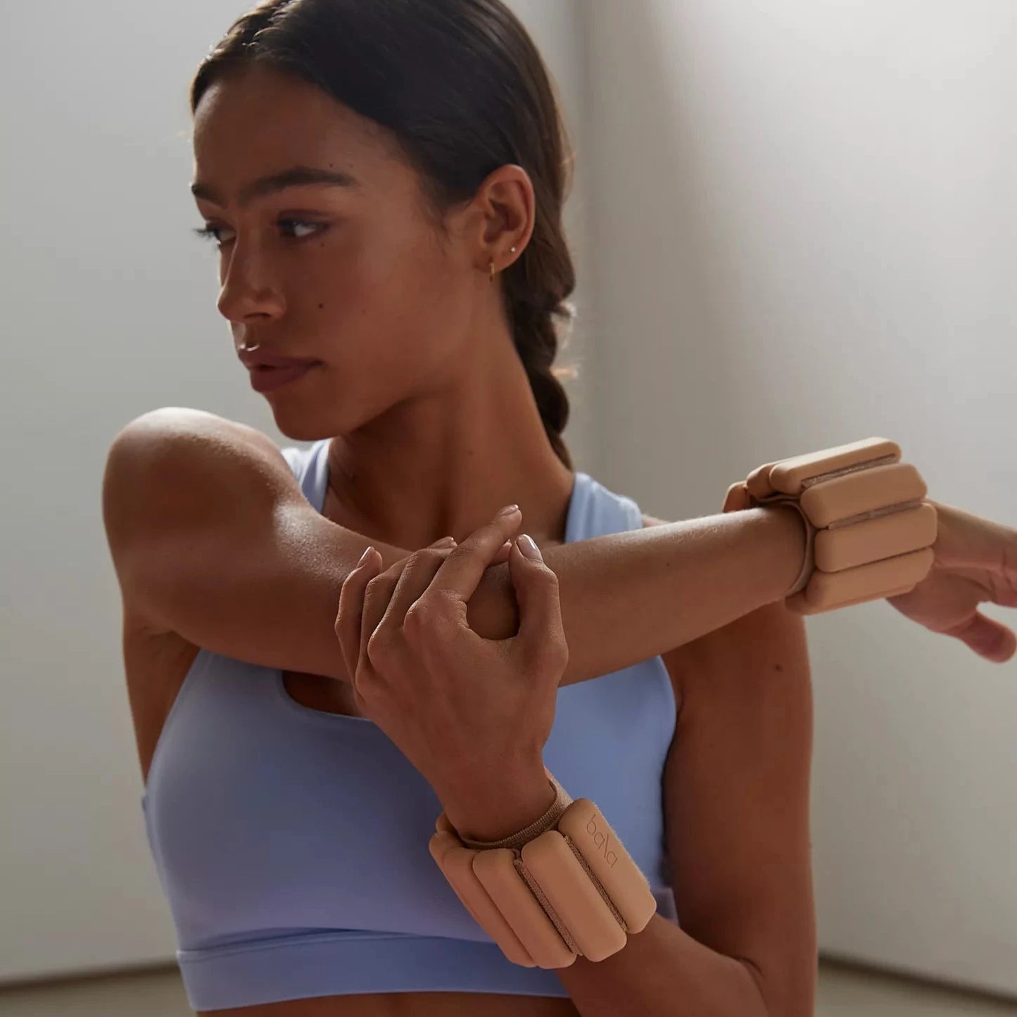 woman working out with bala bangles on wrists