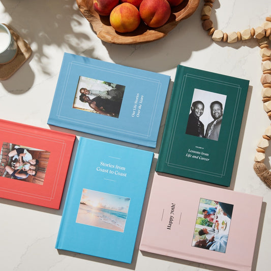 Five sample books displayed on a table