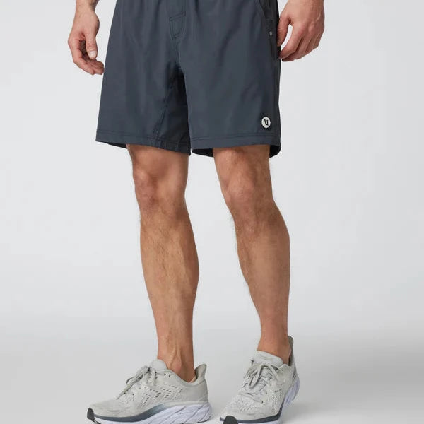 man standing wearing athletic shorts with sneakers