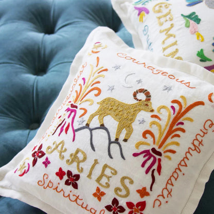 aries pillow with goat and volcanos against blue couch