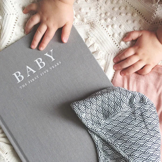 Baby hands on baby book