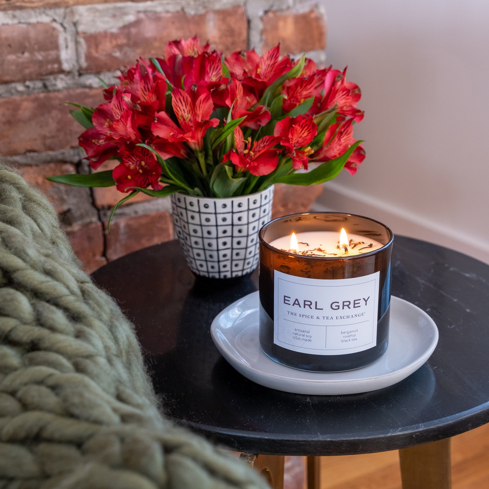 earl grey scented candle on an end table
