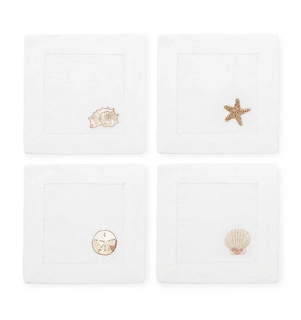 set of four linen cocktail napkins with different seashells for beach house