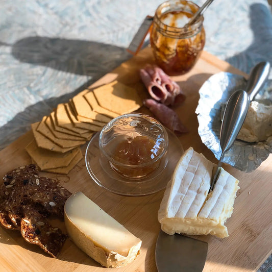 glass butter dish on cheese board