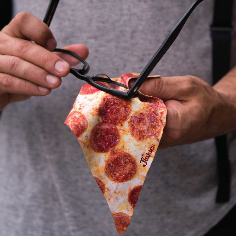 person wiping glasses on pizza microfiber cloth