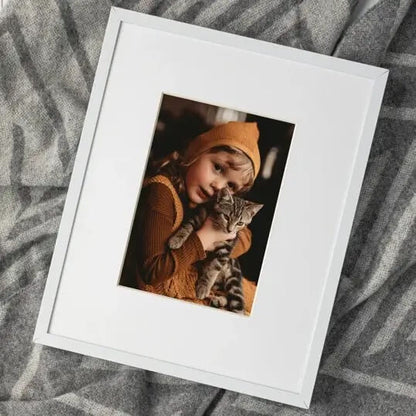 white framed photo kid with cat