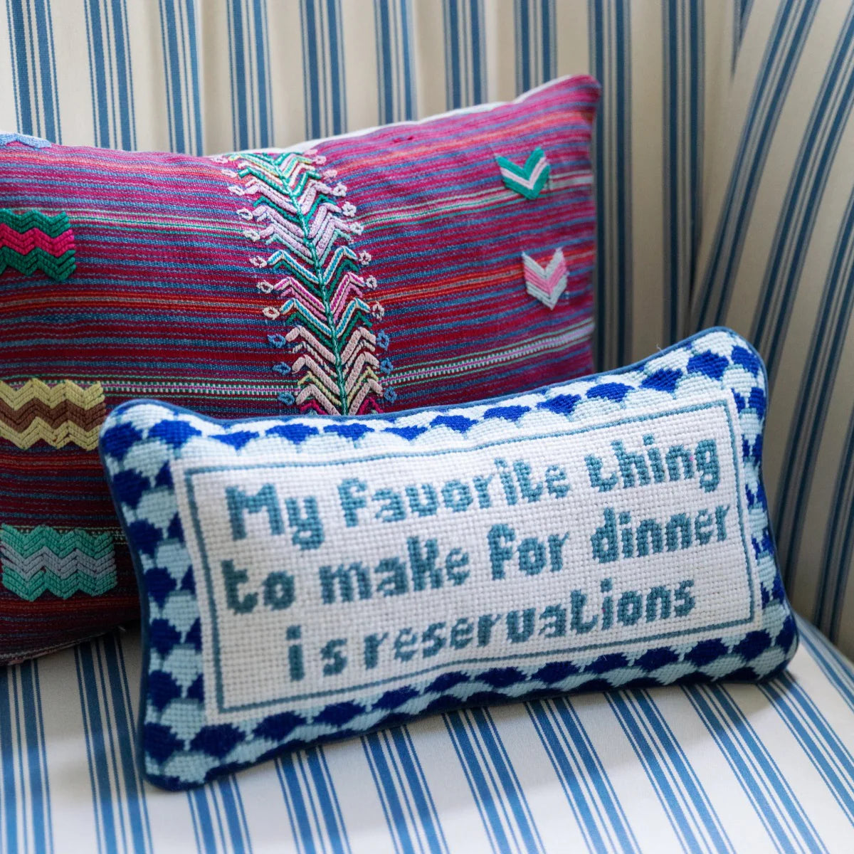 needlepoint pillow that says my favorite thing to make for dinner is reservations