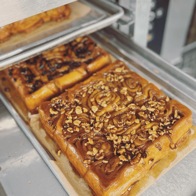 walnut and raisin sticky buns in baking trays