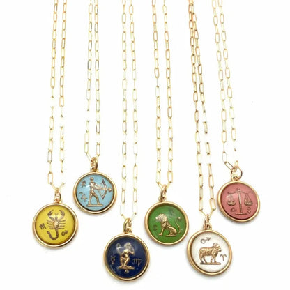 zodiac charms on gold paperclip necklace