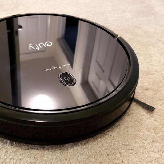 black circular vacuum on rug